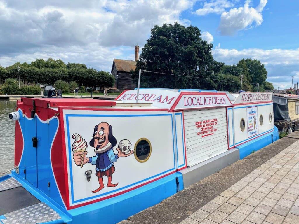 bright canal boat with comic Shakespeare character