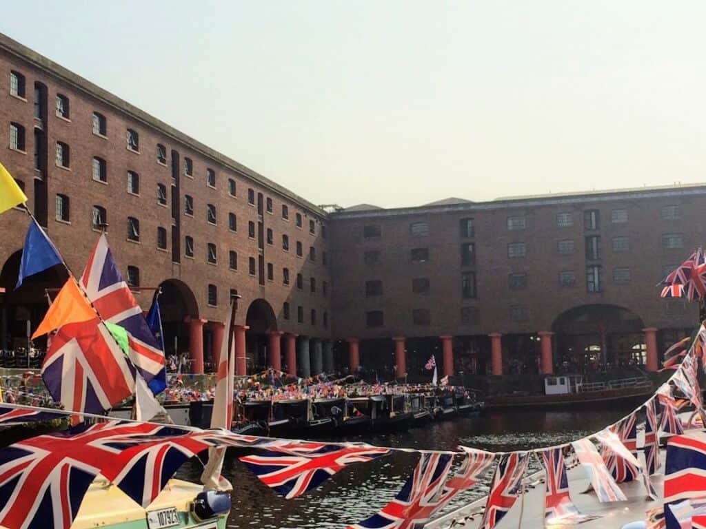 Royal Albert Dock buildings with boats and flags